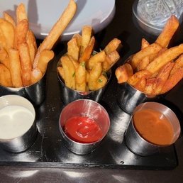 Fries sampling as a complimentary appetizer with tasty sauces