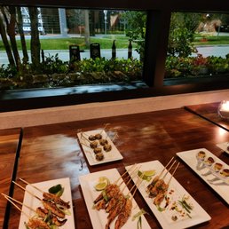Satay Chicken Skewers, Crab Cakes, Meat Balls and Flatbread by the window in private room. Marriott hotel is visible out the window. Satay Chicken Skewers, Crab Cakes, Meat Balls and Flatbread by the window in private room. Marriott hotel is visible out the window.
