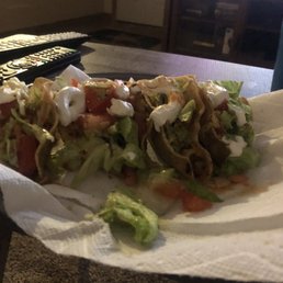 a taco with lettuce and tomatoes a taco with lettuce and tomatoes