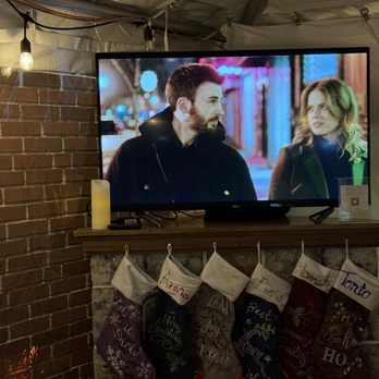 V-NO Wine Bar - Inside the tent - a fake fireplace and a movie - Wine Bars Near Me - Baltimore, Maryland