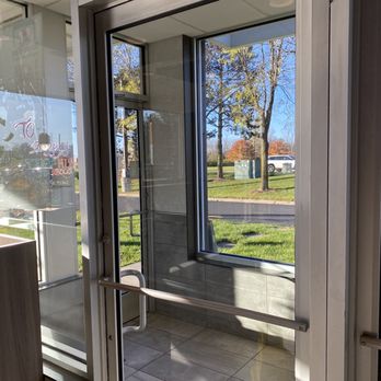 McDonald's - a view of a parking lot through a glass door - Burgers Near Me - Walled Lake, Michigan McDonald's - a view of a parking lot through a glass door - Burgers Near Me - Walled Lake, Michigan