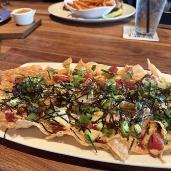 Yard House - Poke Nachos with Stacked Turkey Club in background - Bars Near Me - Houston, Texas Yard House - Poke Nachos with Stacked Turkey Club in background - Bars Near Me - Houston, Texas