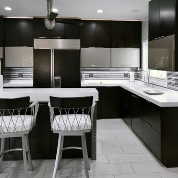 Cai Cabinetry - a kitchen with black cabinets and white countertops - Cabinetry Near Me - Columbus, Ohio