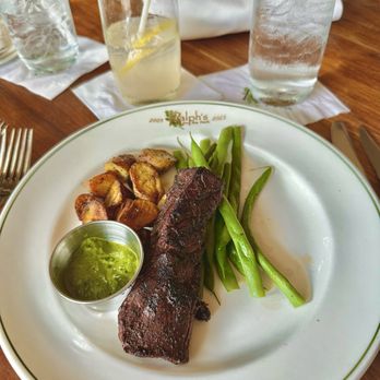 Ralph's on the Park - Cajun spiced hanger steak, green beans, roasted potatoes, with a side of chimichurri. Also pictured: sparkling lavender lemonade mocktail. - Cajun/Creole Near Me - New Orleans, Louisiana