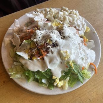 Sizzler - Salad dressing with salad underneath. - Steakhouses Near Me - Los Alamitos, California