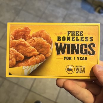 Buffalo Wild Wings - a hand holding a box of buffalo wings - Sports Bars Near Me - Ann Arbor, Michigan