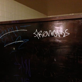 Fuddruckers - Gang graffiti on the men's room stall. - Burgers Near Me - Concord, California