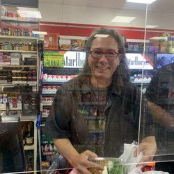 7-Eleven - Mrs Amazing smiling and laughing like usual.  Bags up my order for me. Making my day with laughter. Thanks.