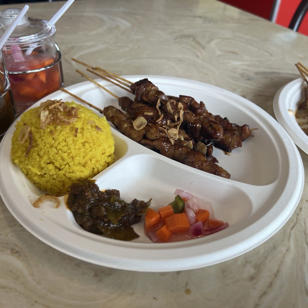 Pork skewers, chicken skewer, yellow rice, and free pickle/and spicy paste (not sure of the name). Pork skewers, chicken skewer, yellow rice, and free pickle/and spicy paste (not sure of the name).