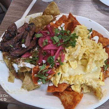 Hungry Fox - Perfect medium rare Skirt Steak accompanied by chilaquiles with cilantro, cheese and crema.  I asked for half/half  red and green salsa - Breakfast & Brunch Near Me - North Hollywood, California