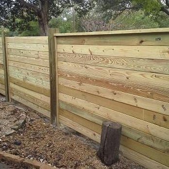 Tutsons Landscaping & Sprinklers - a wooden fence with a wooden post - Fences & Gates Near Me Tutsons Landscaping & Sprinklers - a wooden fence with a wooden post - Fences & Gates Near Me