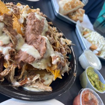 Papis Taqueria - Carnitas Fiesta Nachos. Sour cream, guacamole and pico de gallo on the side. - Mexican Near Me - Old Lyme, Connecticut