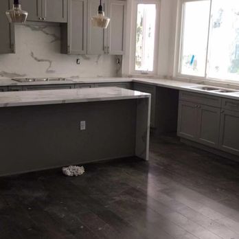 Milestone Kitchen & Bath - a kitchen with a marble island - Kitchen Supplies Near Me - Laguna Hills, California