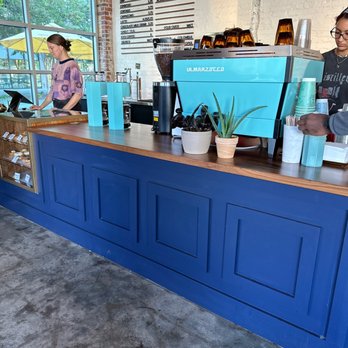 East Pole Poncey Highland - a man and a woman behind the counter - Coffee Roasteries Near Me - Atlanta, Georgia