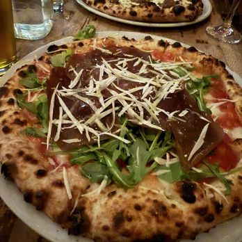 Verde - Foreground: Bresaola Verde Pizza; background: pistachio Pistacchio e Salsiccia - Pizza Near Me - Baltimore, Maryland