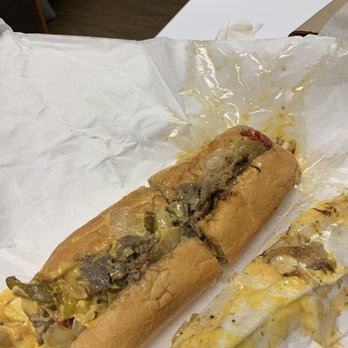 Tat's Delicatessen - Philly Cheesesteak w/cheese wiz, grilled onions and hot peppers. - Delis Near Me - Seattle, Washington Tat's Delicatessen - Philly Cheesesteak w/cheese wiz, grilled onions and hot peppers. - Delis Near Me - Seattle, Washington