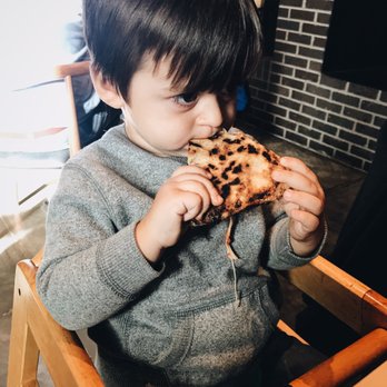 Hinterland Brewery - Devouring his cheese pizza (upside down) - New American Near Me - Green Bay, Wisconsin