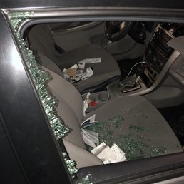 Broken window and ransacked car Broken window and ransacked car