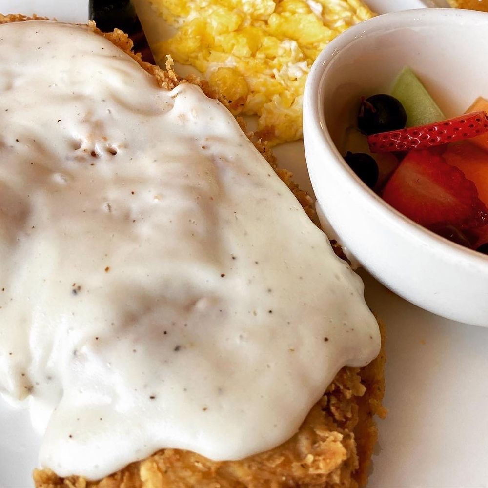 Our Brunch Spot - Chicken fried chicken!! Delish!!! With a side of fresh fruit, scrambled eggs and a stack of pancakes - Breakfast & Brunch Near Me - Keller, Texas Our Brunch Spot - Chicken fried chicken!! Delish!!! With a side of fresh fruit, scrambled eggs and a stack of pancakes - Breakfast & Brunch Near Me - Keller, Texas