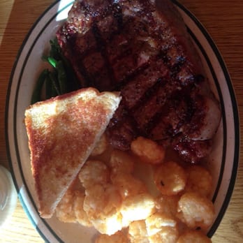 Red Rock Restaurant - Ribeye with ole (pronounced o-lay) the description lead me to believe they were scalloped potatoes but they were tater tots. - American Near Me - Wall, South Dakota Red Rock Restaurant - Ribeye with ole (pronounced o-lay) the description lead me to believe they were scalloped potatoes but they were tater tots. - American Near Me - Wall, South Dakota