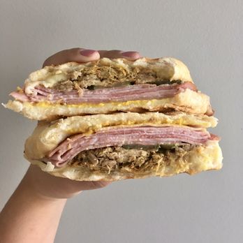 Key West Bistro - a hand holding a sandwich - Coffee & Tea Near Me - Minneapolis, Minnesota