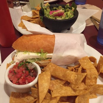 Picante - Mexican City Style Torta. Chips and guacamole in the background. - Mexican Near Me - Berkeley, California