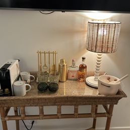 In room amenities include a stocked bar cart.