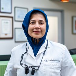 StarBrite Dental - Dr. Munira Lokhandwala DDS with a blue hijab, white labcoat, and loops