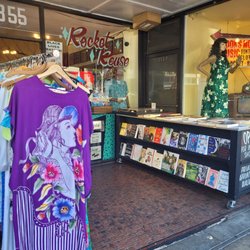 Rocket Reuse - Outside entrance area has a vintage clothing rack display and table with quality used books
