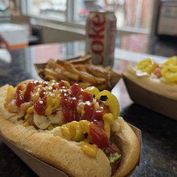 Curious Dog - Hot dog with mustard, ketchup, tater tots, banana peppers, and relish. - Hot Dogs Near Me - Knoxville, Tennessee