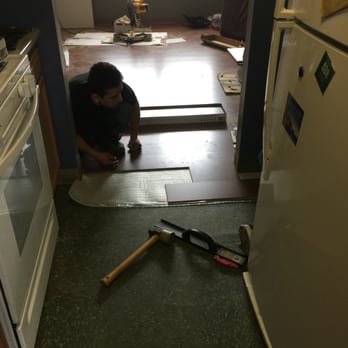 Calvary flooring - a man working on a kitchen floor - Flooring Near Me Calvary flooring - a man working on a kitchen floor - Flooring Near Me