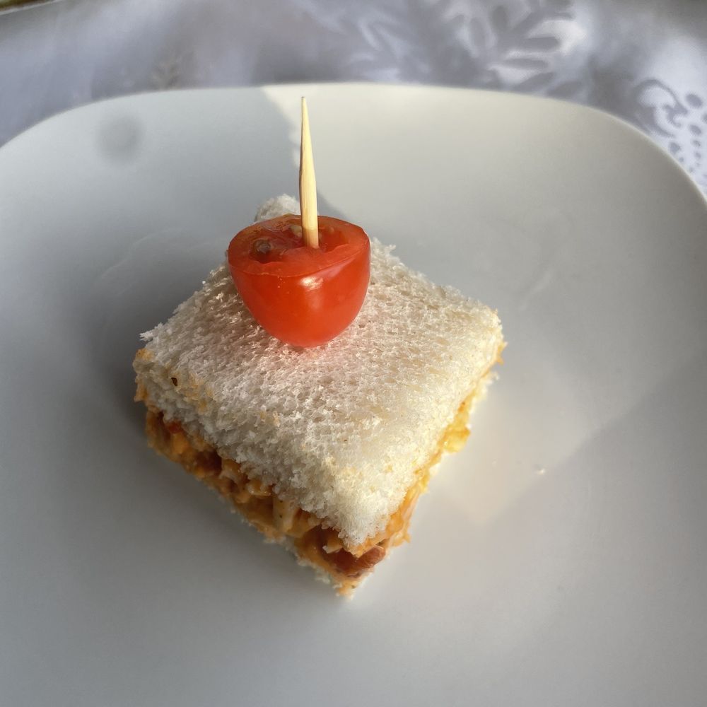 Cafe Bel-Air - a piece of cake with a tomato on top - Mauritius Near Me - Edmonton, Alberta