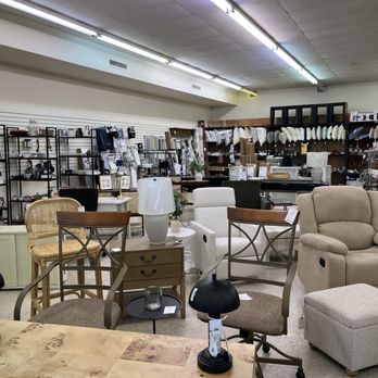 This & That - Furniture - A furniture store interior showcasing chairs, lamps, and home decor items arranged on shelves and tables. - Home Decor Near Me - Fort Wayne, Indiana