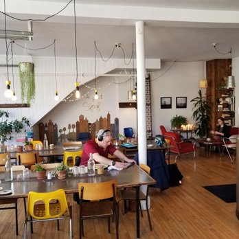 Café Sfouf - a man sitting at a table - Cafes Near Me - Montreal, Quebec