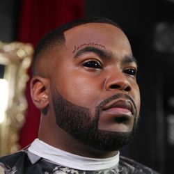 Designer high bald fade with detailed beard grooming.
