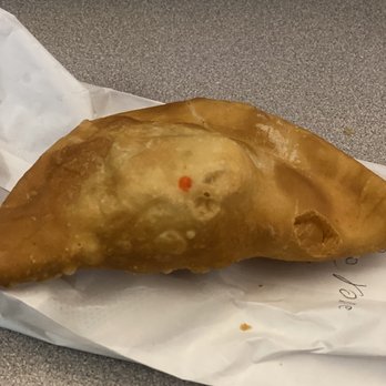 Empanadas Monumental - a piece of food on a piece of paper - Empanadas Near Me - Paterson, New Jersey