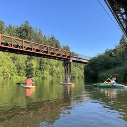 Under the railroad and the walking bridges.