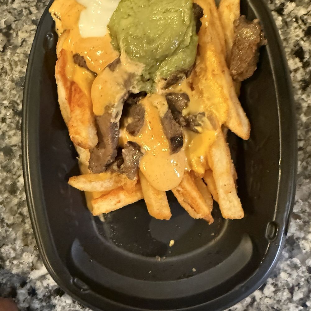Taco Bell - Steak and guacamole fries! Hard to see but guacamole has brown spots in it and it was cold! Plus they didn't even fill the container - Fast Food Near Me - Queen Creek, Arizona