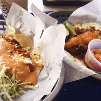 Taco Joint - Fried fish taco with spicy peanut sauce - and a barbacoa taco with habanero sauce. - Mexican Near Me - Austin, Texas Taco Joint - Fried fish taco with spicy peanut sauce - and a barbacoa taco with habanero sauce. - Mexican Near Me - Austin, Texas