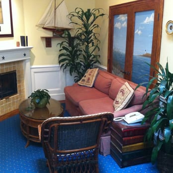 Snug Harbor Inn - The Inn's living room, with a fireplace and seating. It is also the room they serve wine and cheese in the evening. - Hotels Near Me - Avalon, California Snug Harbor Inn - The Inn's living room, with a fireplace and seating. It is also the room they serve wine and cheese in the evening. - Hotels Near Me - Avalon, California
