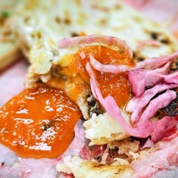 Pupuseria Jireh - Pupusas topped with red tomato sauce and pickled cabbage slaw.