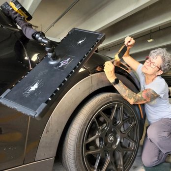 The Dent Queen - The Dent Queen using her skills to repair the dings on the hood of this Mini Cooper - Mobile Dent Repair Near Me