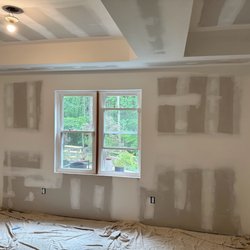 Leo Home Improvement - Professional drywall taping and mudding in progress, creating smooth surfaces for flawless paint application.