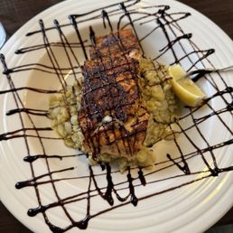 Blackened salmon over pearl onion risotto with balsamic drizzle. Blackened salmon over pearl onion risotto with balsamic drizzle.