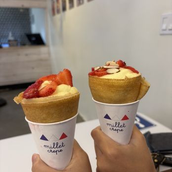Millet Crepe - left: Custom Crepe with custard filling + strawberries right: Custom Crepe with custard filling + strawberries + crunchy flakes - Creperies Near Me - Los Angeles, California Millet Crepe - left: Custom Crepe with custard filling + strawberries right: Custom Crepe with custard filling + strawberries + crunchy flakes - Creperies Near Me - Los Angeles, California
