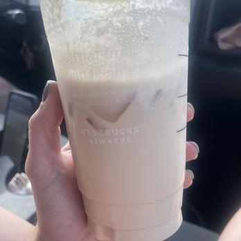 Starbucks - a hand holding a cup of iced coffee - Coffee & Tea Near Me - Fargo, North Dakota Starbucks - a hand holding a cup of iced coffee - Coffee & Tea Near Me - Fargo, North Dakota