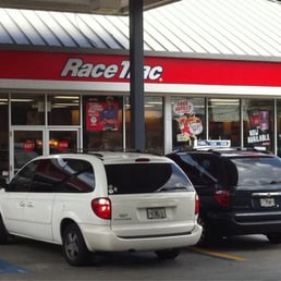 two cars parked in front of a racetrac store two cars parked in front of a racetrac store