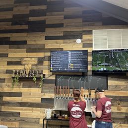 two people standing in front of a bar two people standing in front of a bar