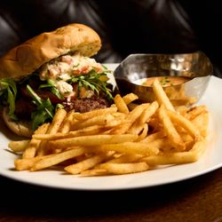 Blaqcat Ultra Lounge and Cuisine - A juicy Mediterranean lamb and beef burger, topped with creamy tzatziki for the perfect flavor kick.