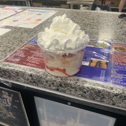 Small dish coffee ice cream with whipped cream and cherries